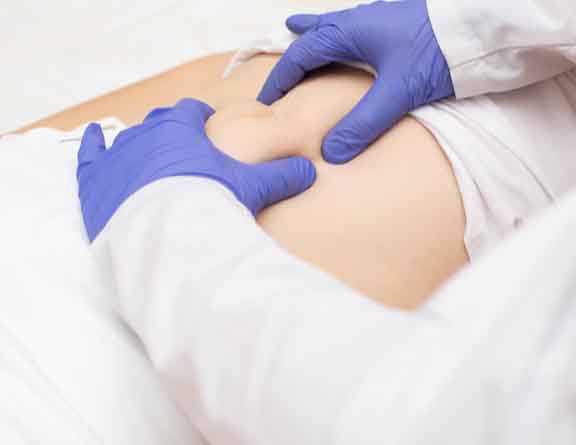 Doctor touching the stomach area for examining Uterine Fibroid in pune