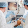 Orthopedic Doctors performing arthroscopic surgery on patient