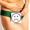 Female with her hand on her abdomen and a sad smiley face card on her underwear