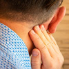 Man having pain behind the ear