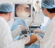 Orthopedic Doctors performing arthroscopic surgery on patient