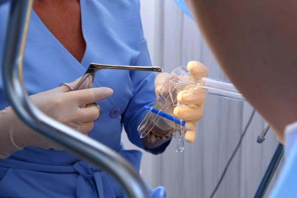 Female consulting gynecologist for vaginal discharge treatment