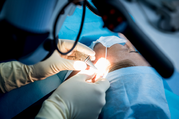 Doctors performing tympanoplasty for perforated eardrum