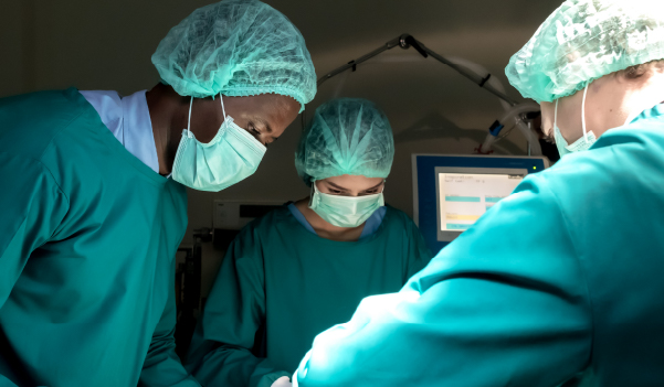 Surgeons performing varicocele surgery in operation theater
