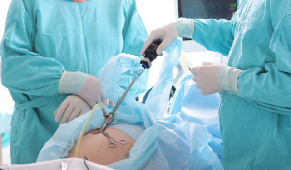 Doctor examining patient's stomach area for hernia diagnosis