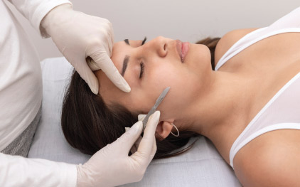 Woman Getting dermaplaning treatment in delhi